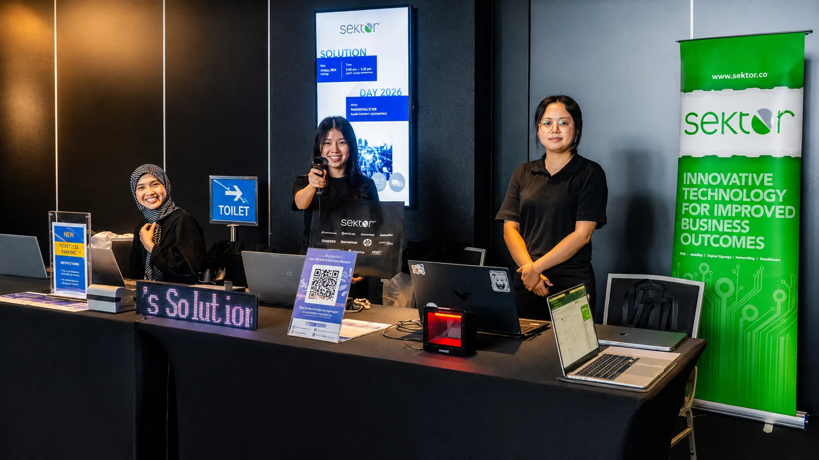 Crew at the Sektor Day 2026 registration desk with laptops and QR scanner